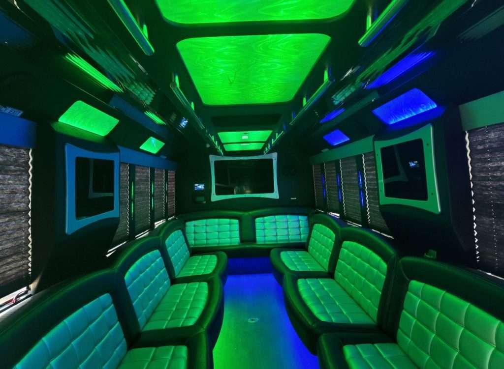 Castle Rock Limo Services 3 Interior of a party bus with black and gray leather seats and green lighting.